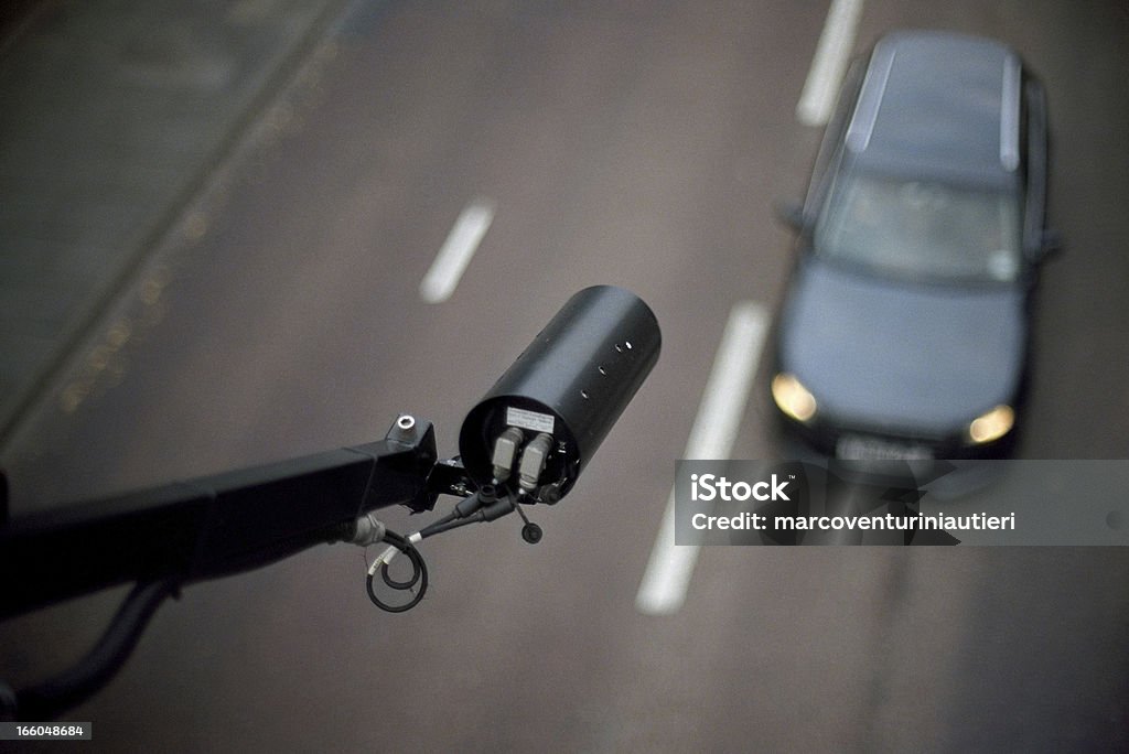 CCTV pointing on car - view from above, blurred background CCTV mounted over an English main road. Focus on the camera only. Wide aperture (f:1.2) to isolate the foreground. Some natural vignetting occurring. Camera - Photographic Equipment Stock Photo