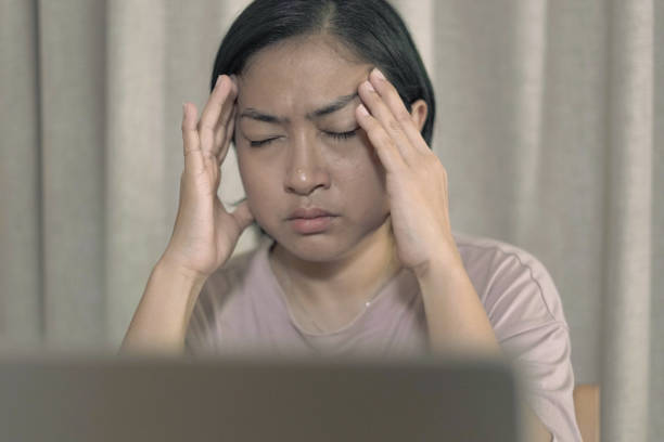 istock Woman holding her head Feeling stressed 1660488912