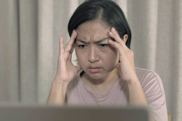 istock Woman holding her head Feeling stressed 1660488933