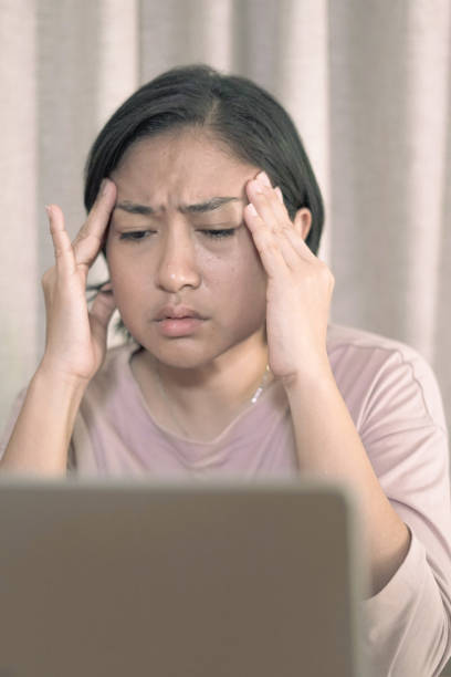 istock Woman holding her head Feeling stressed 1660489491