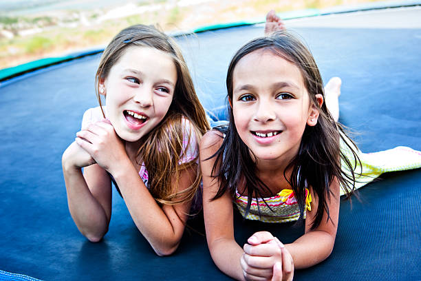 istock Girls Laying on Trampoline 166049371