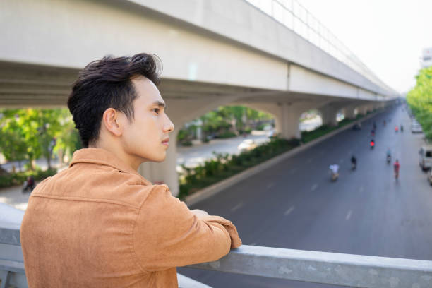 istock Portrait of young Asian man outside 1660498556