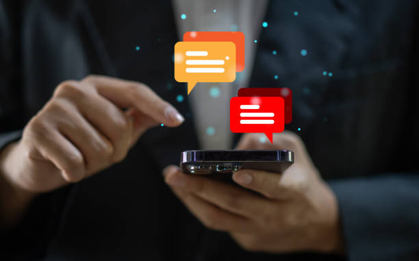 istock Human hand using smartphone typing Live chat chatting and social network concepts, chatting conversation working at home in chat box icons pop up. Social media marketing technology concept 1660503662
