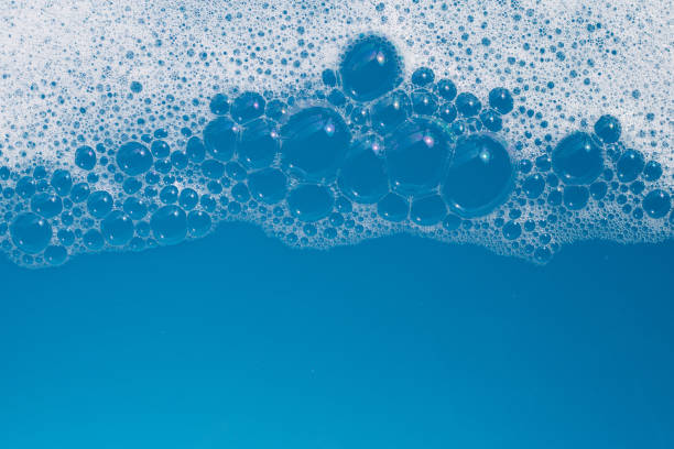 istock Detergent foam bubble on water. Blue background, Soap sud 1660524328