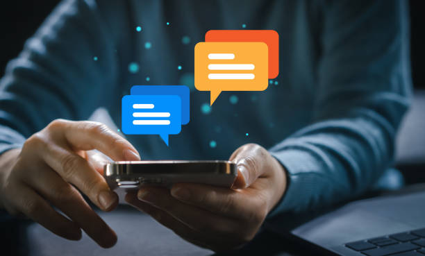 istock Human hand using smartphone typing Live chat chatting and social network concepts, chatting conversation working at home in chat box icons pop up. Social media marketing technology concept 1660529213