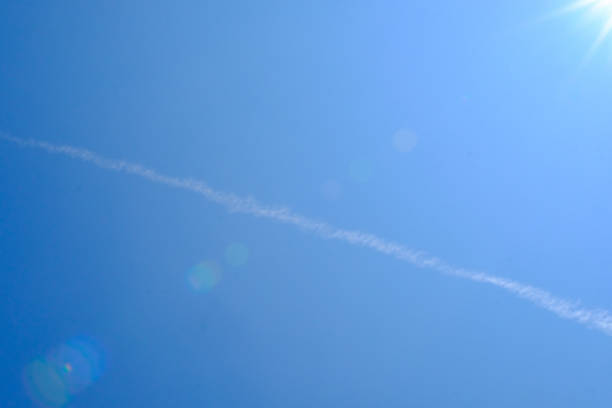 istock Jet plane smoke streaking the sky 1660532390