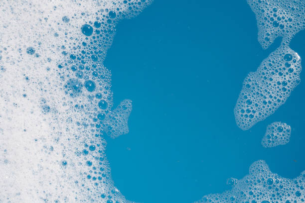 istock Detergent foam bubble on water. Blue background, Soap sud 1660534478