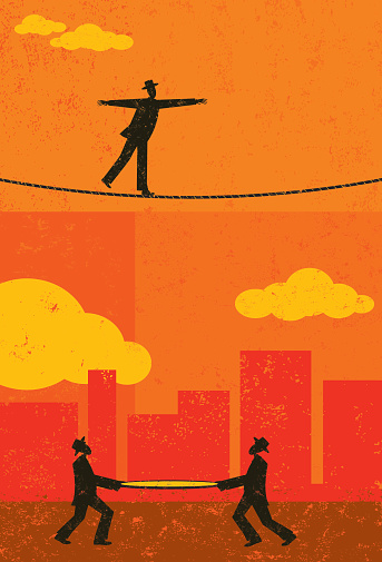 A retro businessman walking a tightrope with two men and a safety net underneath in case he falls. The people & rope and background are on separate labeled layers.