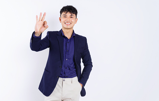 Photo of young Asian businessman on white background