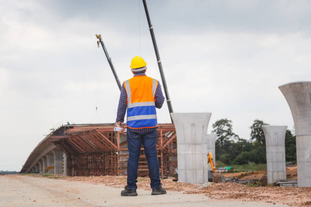 istock Rear view of Engineer under inspection and checking project at the building site, Foreman worker in hardhat at the infrastructure construction site 1660565516