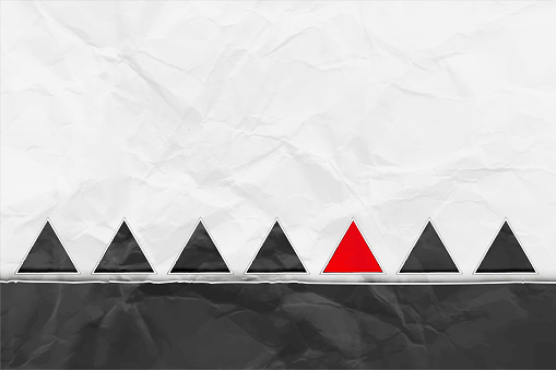 Crumpled paper black and white backgrounds with a row of solid similar identical triangles, one of them being red - suitable to use as wallpaper, label or posters backdrops and templates. There is No people and No text. There is copy space for text.