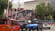 istock 4k video many cars and motorcycles cross the highway in the city of Ambon 1660624822