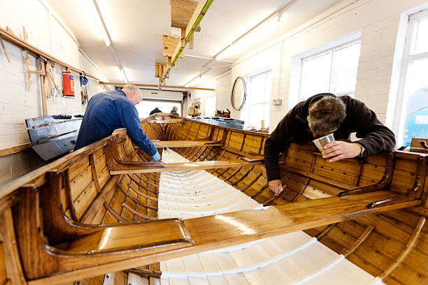 istock Team varnishing a gig boat 166063460