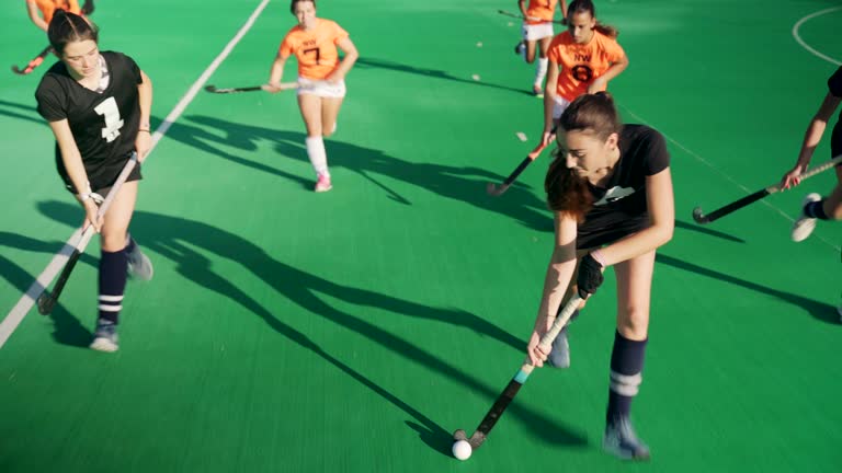 On the Attack: Skilled female Field Hockey Player vs. Relentless Defenders