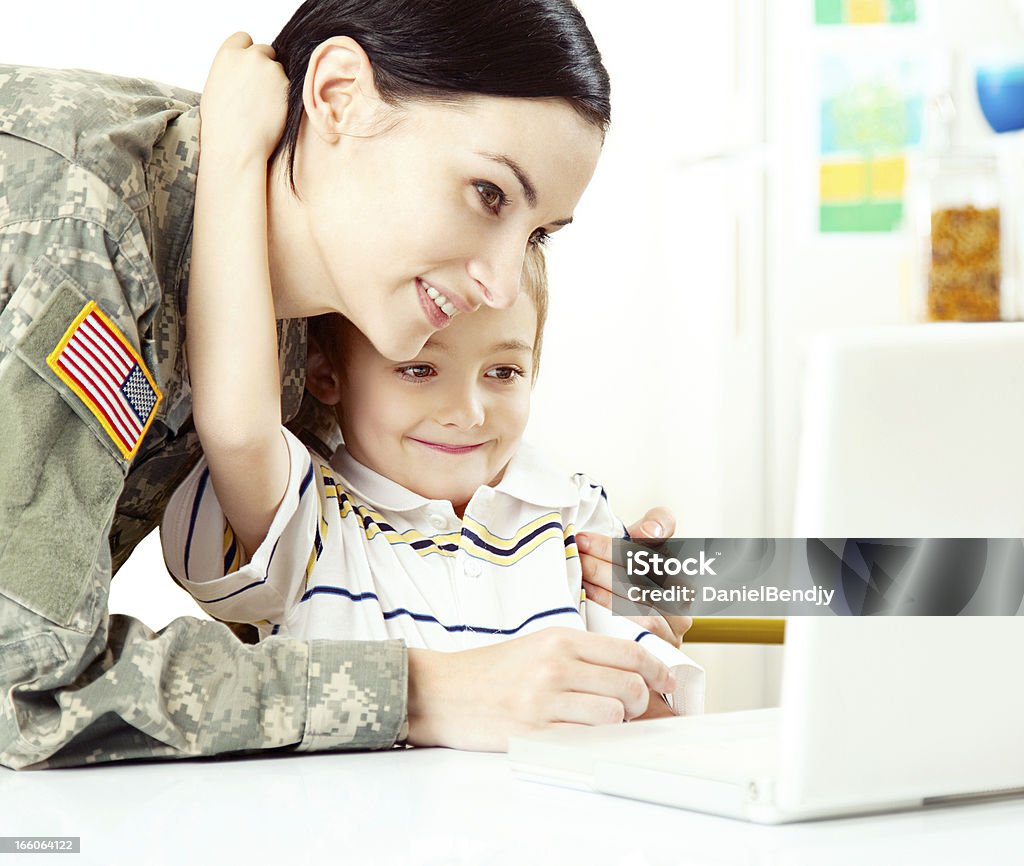 Female American Soldier with Son Female American soldier with son and laptop.  Adult Stock Photo