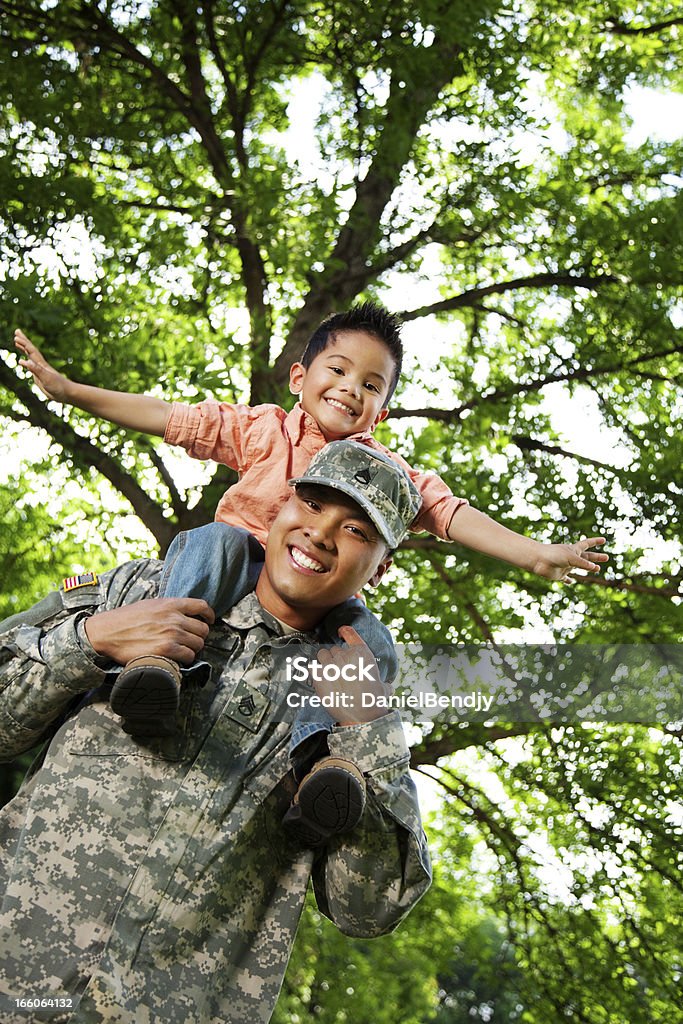 Army Family Series: Young American Soldier & Son Young American soldier and son in the park. Carrying On Shoulders Stock Photo