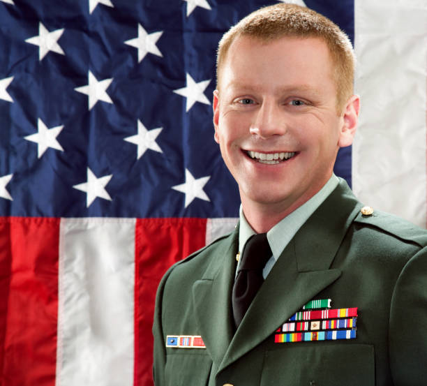 istock Decorated American Soldier with Class A Uniform Against USA Flag 166064173