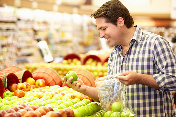 istock Man Shopping For Produce In Supermarket 166065983