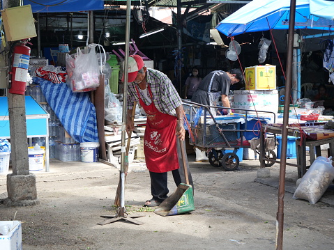 2023-05-01:Lampang Thailand:Man or cleaning staff sweep the garbage in the market.