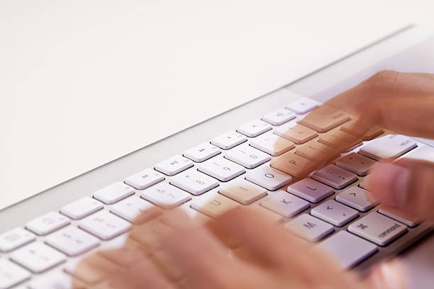 Hands Typing on a Keyboard stock photo