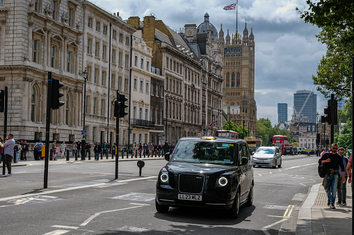 London/UK-26/07/18: electric Hackney carriage at charging station with the power cable supply plugged in. First fully electric cab, the Dynamo, was launched with a 187 mile range in Oct 2019 in London