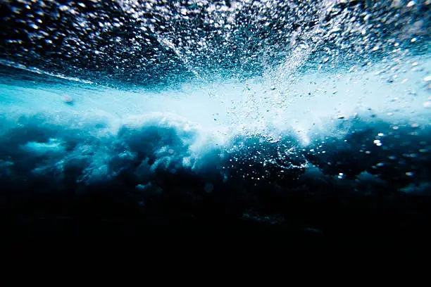 Wave crashing with bubbles underwater