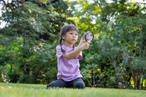 istock Using a magnifying glass to look at insects in the grass can be an exciting and educational activity for children. 1660714137