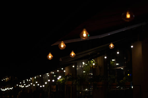 istock Loft-style lamps in a street cafe, copy space. 1660718553