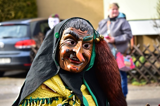 Deizisau, Germany – February 19, 2017: A group of people in festive masks participating in a traditional carnival parade in Deizisau, Germany
