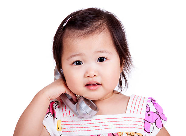 istock Asian Infant with Phone Isolated on White 166073292