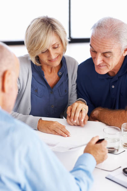 istock Man explaining investment plans to senior couple 166073316