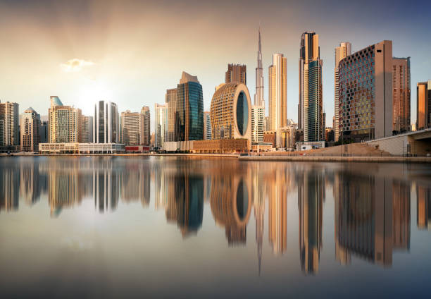 istock Dubai skyline with reflection at dramatic sunset with sun in United Arab Emirates 1660734906