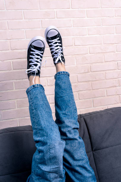 istock girl, is lying on the sofa with her legs thrown up 1660742961