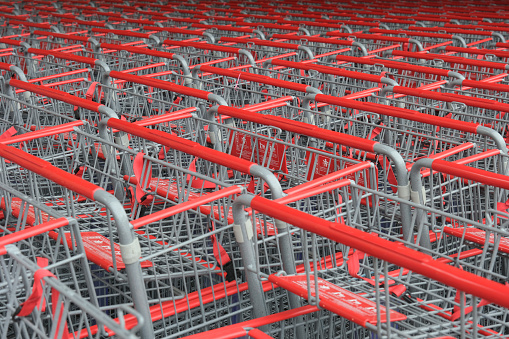 Red shopping carts in front of a retail store.