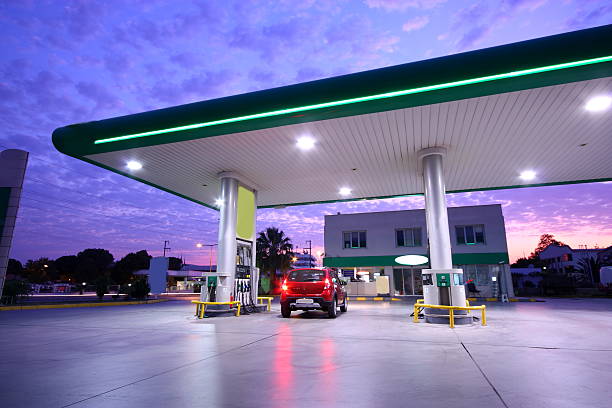 Refueling station Illuminated Service station at night. station stock pictures, royalty-free photos & images