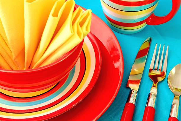 Bright Colorful Place Setting in red, yellow and turquoise stock photo