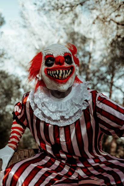 istock evil clown with a creepy smile a in the woods 1660774327