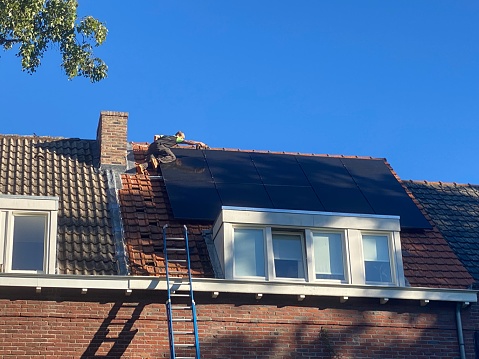 Brunssum  the Netherlands, - September 05,  2023.  Finishig tuch Installing Solar panels on a residential building for a durable energy consumption.