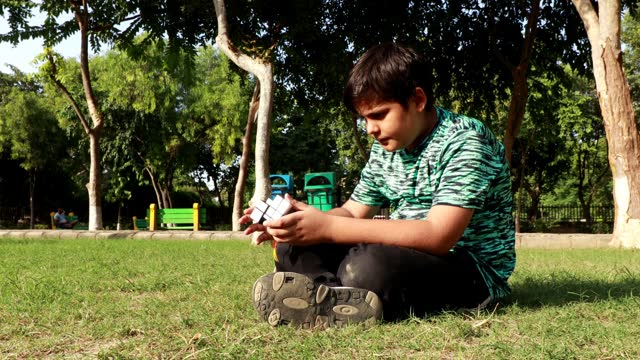 Elementary student playing with rubix or rubiks cube