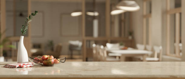 istock Copy space on a marble tabletop with a blurred modern Scandinavian dining room in the background. 1660801480