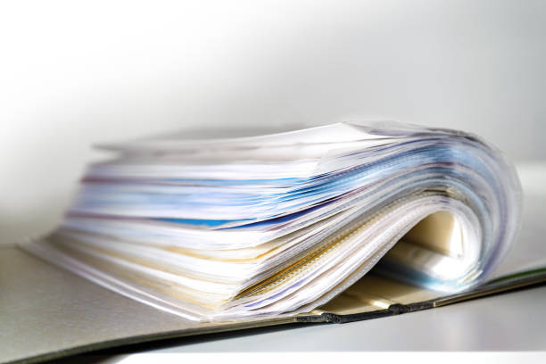 istock Opened ring binder with a lot of documents in transparent sleeves or punched pockets, concept for office organization, bureaucracy and business, copy space, selected focus 1660804663