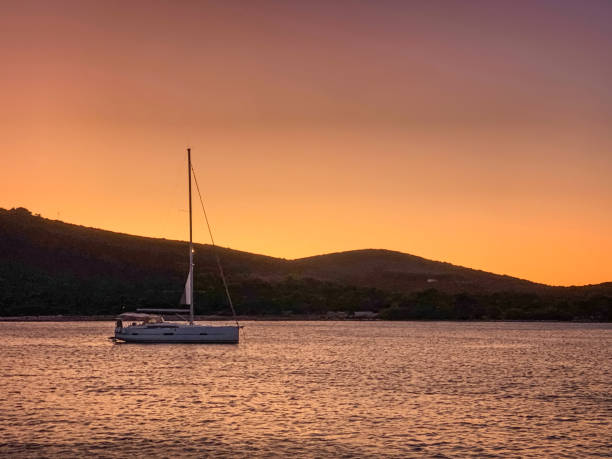 istock Anchored sailboat at sunset 1660804667
