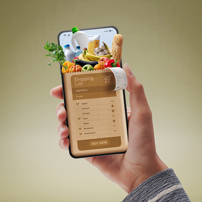 Online grocery shopping app: customer holding a smartphone and ordering groceries online