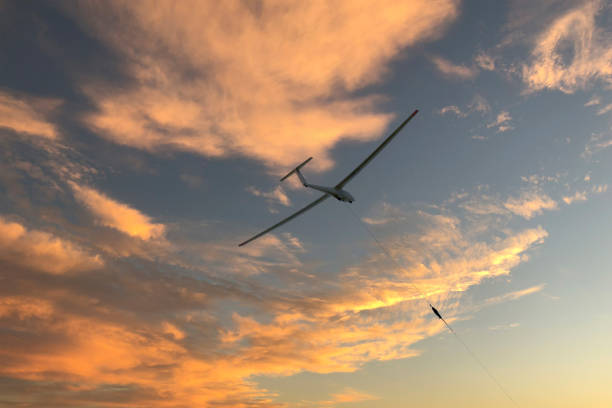Glider in the take-off phase with a beautiful sunset sky