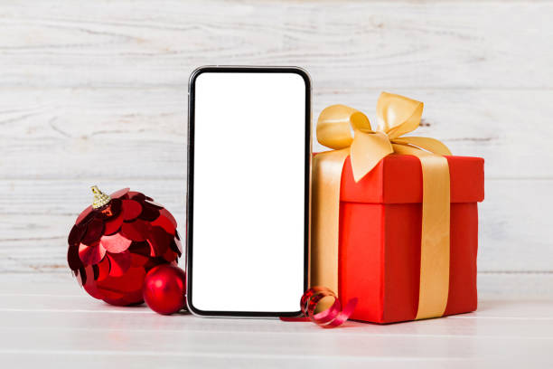 istock Digital phone mock up with rustic Christmas decorations for app presentation with empty space for you design. Christmas online shopping concept. Tablet with copy space on colored background 1660833911