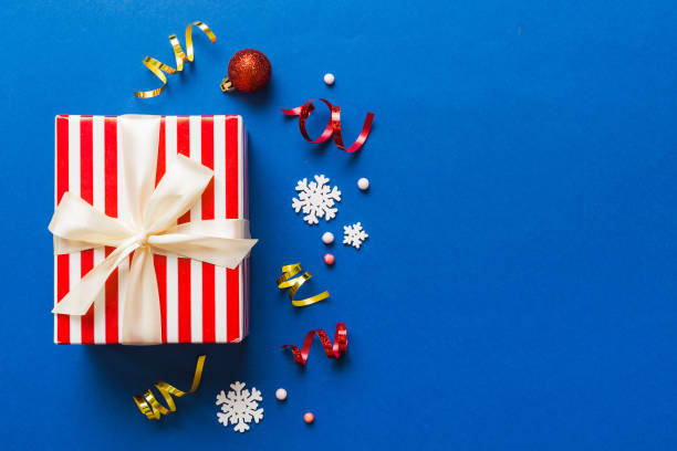 istock Top view Flat lay Christmas decorations and gift box on colored background with copy space. Christmas or Happy New Year composition 1660833918