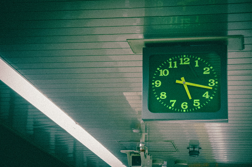 White clock in train station building.