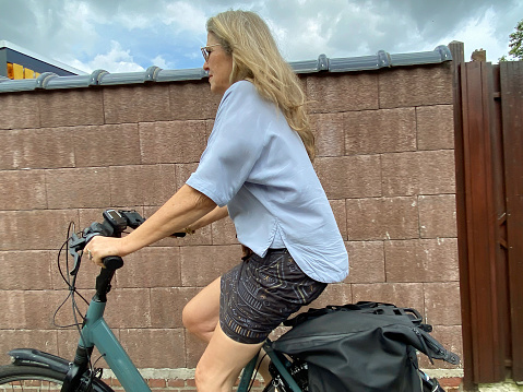 Woman  leaving  for chopping on her e-bicycle