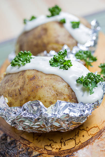 istock fresh baked potatoe with sour cream 166085646