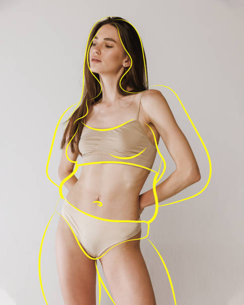 Portrait of posing fit girl in lingerie with drawn silhouette overweight woman around body against studio background. Health care. Portrait of posing fit girl in lingerie with drawn silhouette overweight woman around body against studio background. Health care. Concept of healthy eating, sport, diet, selfcare. Copy space for ad. pudgy woman pictures stock pictures, royalty-free photos & images